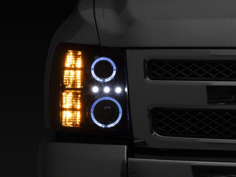 Raxiom 07-13 Chevrolet Silverado 1500 LED Halo Projector Headlights- Black Housing- Clear Lens