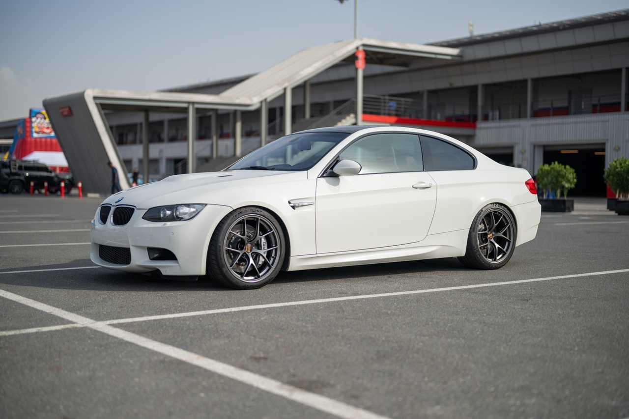 A white modified BMW M3 E92 in a parking lot | ATOMIC-SHOP